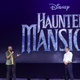 Justin Simien (left) talks haunts galore onstage at D23.